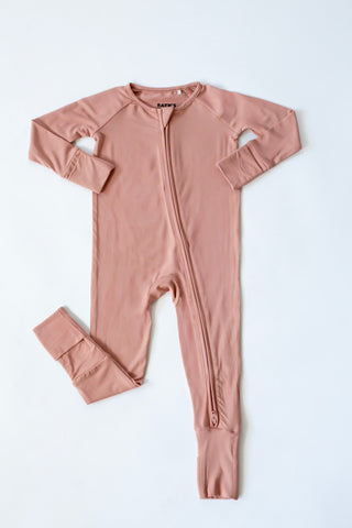Pink baby onesie with a zipper on a white background