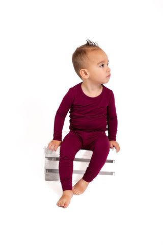 child wearing maroon bamboo pajama set cozy sleepwear